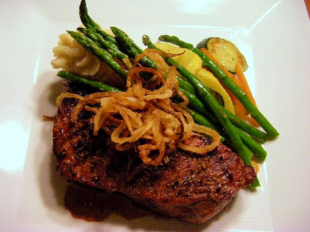 Juicy, grilled New York steak with truffle whipped potatoes, sauteed seasonal vegetables and a port wine sauce